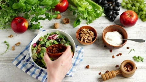 Waldorf salad. Adding raisins to a dish. Stock Footage 139740388