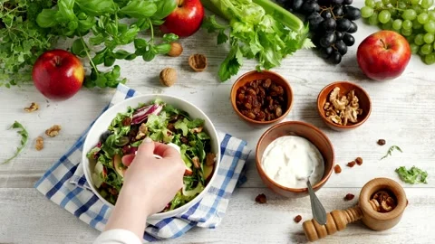 Waldorf salad. Decorate the dish with a basil leaf. Stock Footage 139740405