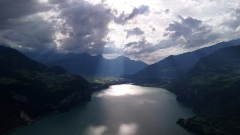 Walensee lake, sun light ray between clouds, nature Switzerland, aerial Stock Footage 282967568