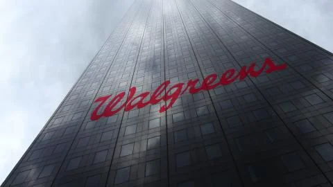 Walgreens logo on a skyscraper facade reflecting clouds. Editorial 3D rendering Ilustración de archivo