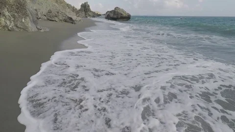 Walk above the Waves Foam in a Sandy Beach Stock Footage 75891911
