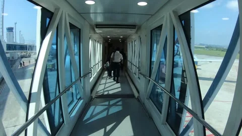 Walk on the aerobridge to the plane Stock Footage 245098529