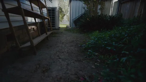 Walk along the back darkside of a house, garden and shed Stock Footage 164885374