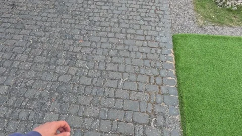 Walk along the historical paved path, lawn, mounds of small stones Stock Footage 246386612