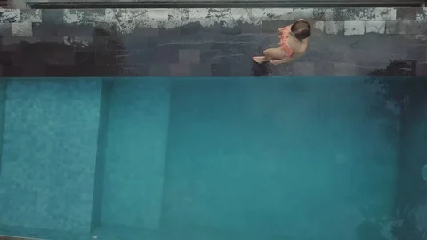 Walk along the pool top down view aerial footage perfect time on the villa Stock Footage 100274514