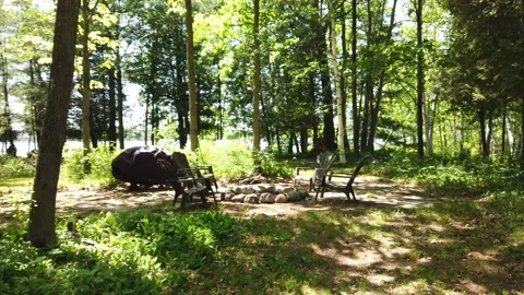 A walk around a fire pit in the woods 4K Stock Footage 133564788