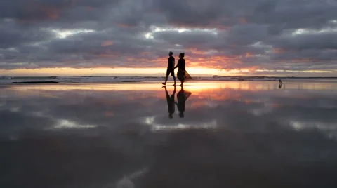 Walk the beach with perfect reflection in sand. HD Video stock 44622750