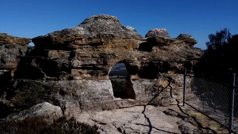 Walk into cave on a cliff to view on the other side. Stock Footage 99614314