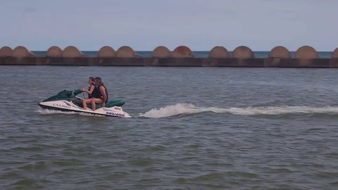Walk on the hydrocycle by sea waves. Spanish beaches in Catalonia. Stock Footage 75583433