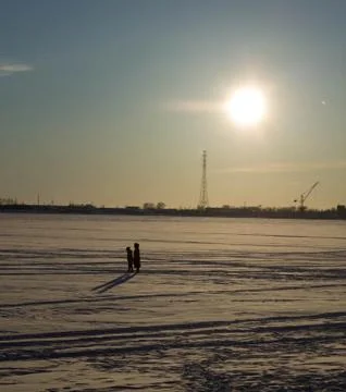 Walk on the ice under the rays of the winter sun Stock Photos