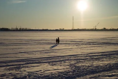 Walk on the ice under the rays of the winter sun Stock Photos