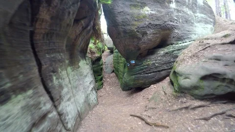 Walk in narrow path in sand rocks corridor like in labyrinth. 動画素材 77263650