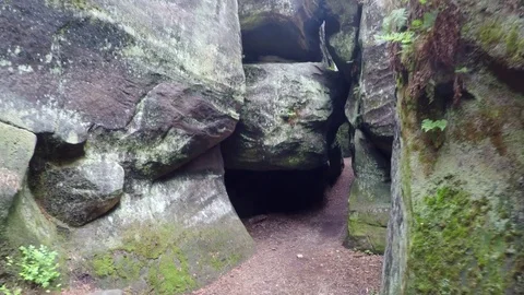 Walk in narrow path in sand rocks corridor like in labyrinth. 動画素材 77264062