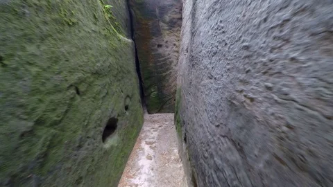 Walk in narrow path in sand rocks corridor like in labyrinth. 動画素材 77264202