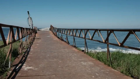 Walk on the old rusty bridge on the sea Stock Footage 102303567