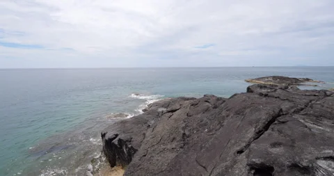 Walk over volcanic rocks of small islet to other side, scenic nature of Tioman Stock Footage 314770250