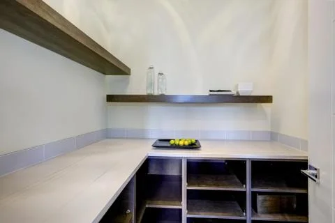 Walk-in pantry features built-in pantry shelves. Northwest, USA. Stock Photos