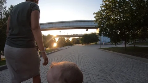 Walk in the park under the bridge, sunset time. 4k. Timelapse Stock Footage 122804824