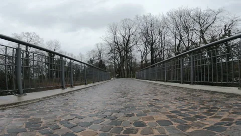 Walk pov on cobblestone pathway on a bridge at Sparrenberg Castle in a park o Stock Footage 314653381