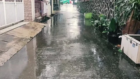 Walk in the rain in a settlement Stock Footage 234803960