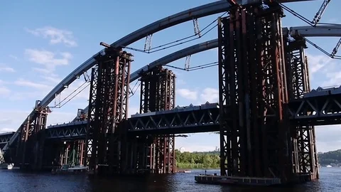 Walk the river under the railway bridge under construction in the city of Kiev. Stock Footage 82196264