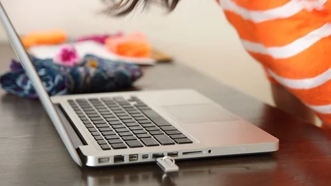 Walk to the table and start the computer Stock Footage 114138447