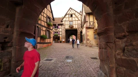 Walk through Dolder Tower gate to village street, half-timbered houses around Stock Footage 147953804