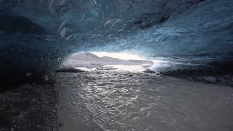 Walk through an Ice Cave river showing the end of a melting glacier in Iceland Stock Footage 260599588