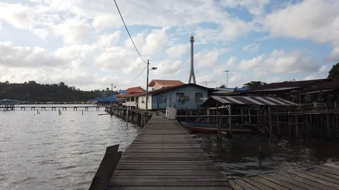 Walk through Kampong Ayer with background of Sungai Kebun Bridge Stock Footage 100994178