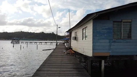 Walk through Kampong Ayer with background of Sungai Kebun Bridge Stock Footage 100994259