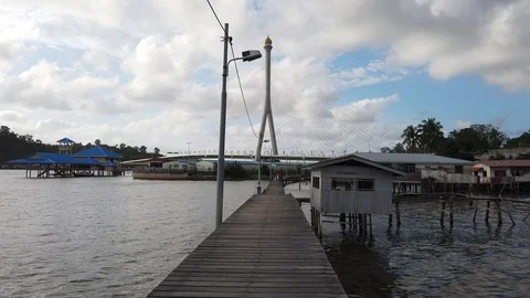 Walk through Kampong Ayer with background of Sungai Kebun Bridge Stock Footage 100994387