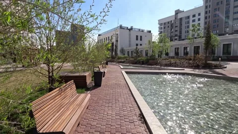 Walk through a new residential complex with fountains, a garden, a park Stock Footage 241103641