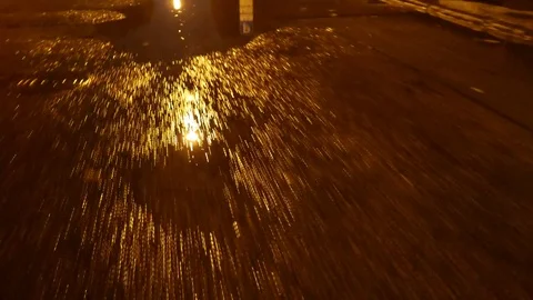 Walk through puddles on the pavement in the night. 4K UHD Video stock 69715215