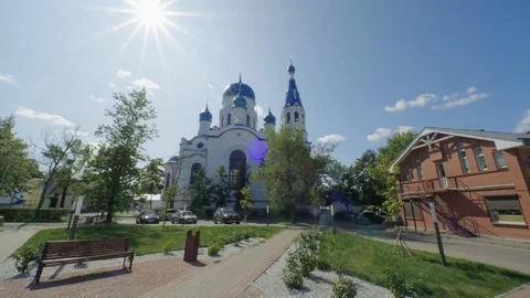 Walk through the square with a view of the white stone Church Stock Footage 123917225