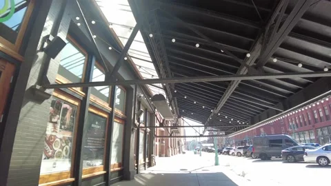 Walk under awning on busy older street Stock Footage 237027686