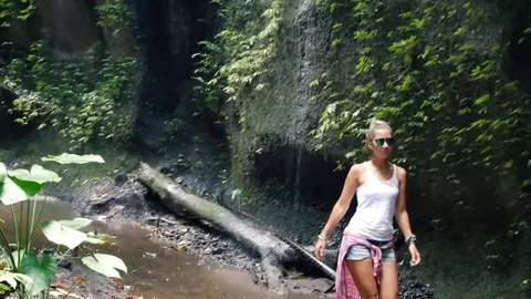 Walk to the waterfall along the path in the rainforest. Bali, Stock Footage 73757145