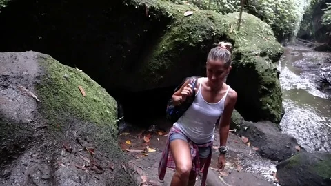 Walk to the waterfall along the path in the rainforest. Bali, Indonesia. Stock Footage 84787094