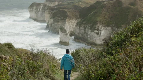 Walker on the cliff path at Flamborough Head Stock Footage 221502491