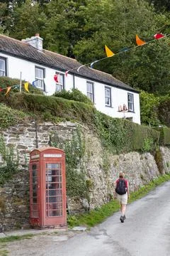 Walker in Flushing Village, Cornwall Stock Photos