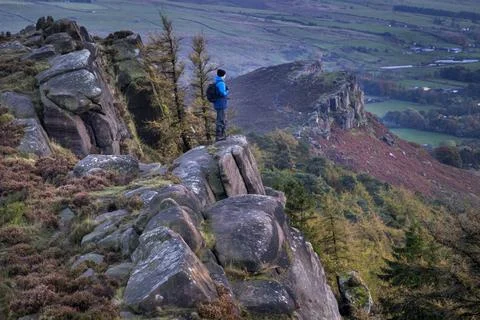 Walker looking out over Hen Cloud from The Roaches rock formation in autum... Stock Photos