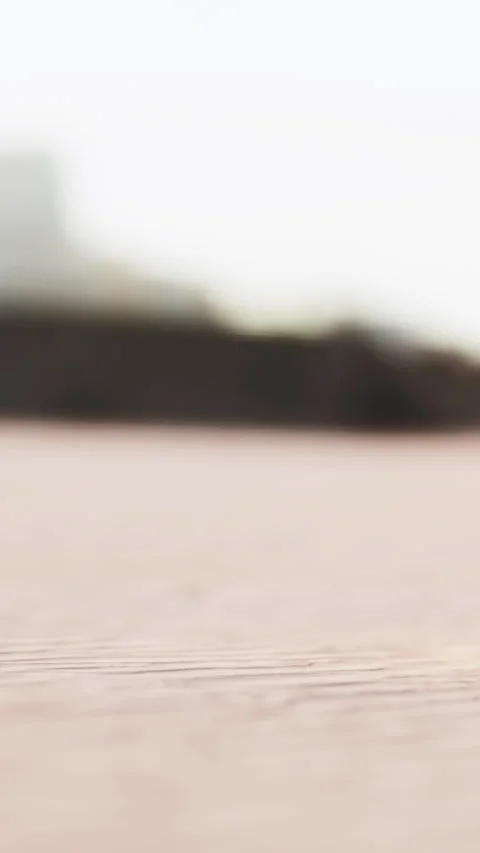 Walker moves on a sandy path near a building during a cloudy day Stock Footage 337943904