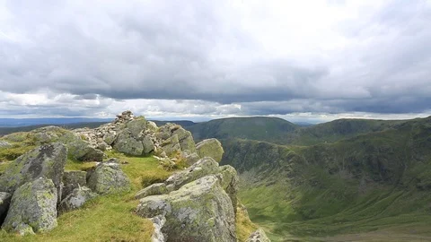Walker at the Summit cairn of Kidsty Pike fell, Lake District National Park Stock Footage 102216371