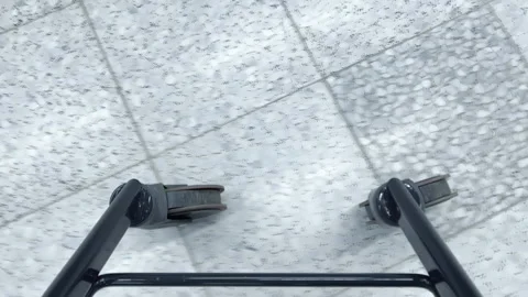 Walker wheels move across smooth floor surface in indoor environment Stock Footage 338261484