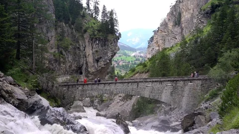 Walkers on a mountain bridge Stock Footage 79752786