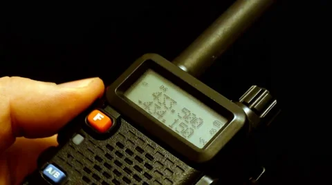 Walkie talkie in hand. On black background Stock Footage 45350423