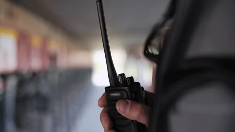 A walkie talkie in the hands of a worker Stock Footage 310780861