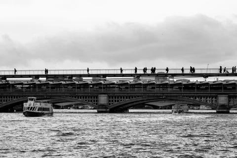 Walking across between the river and cloudy sky. Stock Photos