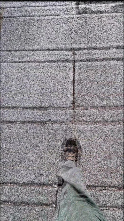 Walking across a pavement stone patterned street ground video Stock Footage 342274638