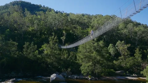 Walking across a swing bridge Video stock 310298257