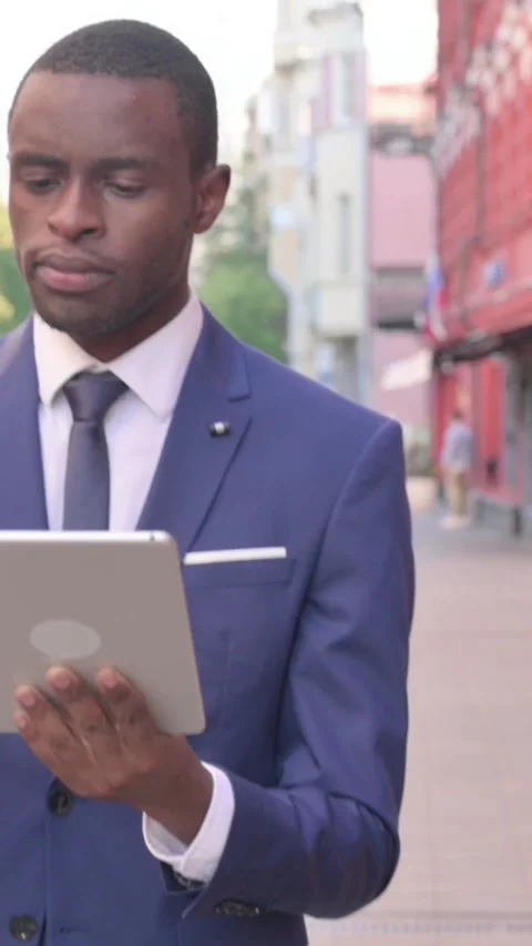 Walking African Businessman Using Tablet, Vertical Video Stock Footage 340031522
